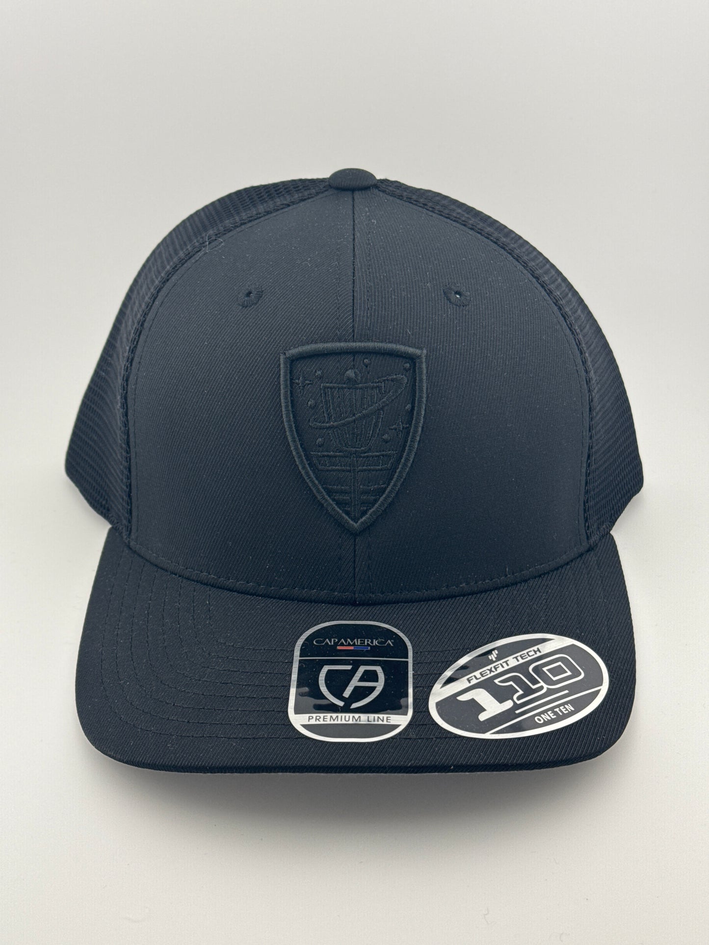 Cosmic Shield Flexfit 110 Mesh Back Trucker Hat - Black/Black